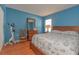 Comfortable bedroom features hardwood floors, dresser, and lots of light, ideal for a restful night at 2285 Hidden Meadows E Dr, Palm Harbor, FL 34683