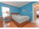 Cozy bedroom with wood floors, natural light, and simple furnishings, perfect for relaxation at 2285 Hidden Meadows E Dr, Palm Harbor, FL 34683