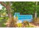 Charming entrance to Hidden Meadows, a deed-restricted community nestled among lush greenery and mature trees at 2285 Hidden Meadows E Dr, Palm Harbor, FL 34683