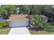 Well-maintained single-story home with lush landscaping, a neatly manicured lawn, and a spacious driveway at 2285 Hidden Meadows E Dr, Palm Harbor, FL 34683
