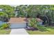 Charming single-story home featuring a well-maintained yard and attached two-car garage at 2285 Hidden Meadows E Dr, Palm Harbor, FL 34683