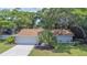 Charming single-story home with a well-maintained lawn, mature trees, and a welcoming curb appeal at 2285 Hidden Meadows E Dr, Palm Harbor, FL 34683
