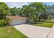 Charming single-story home featuring a well-manicured lawn and a two-car garage at 2285 Hidden Meadows E Dr, Palm Harbor, FL 34683