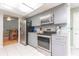 Contemporary kitchen with stainless appliances and adjacent dining area, ideal for gatherings at 2285 Hidden Meadows E Dr, Palm Harbor, FL 34683