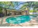 Inviting backyard oasis with a sparkling pool, screened enclosure, and outdoor seating, perfect for entertaining at 2285 Hidden Meadows E Dr, Palm Harbor, FL 34683