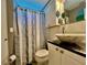 Bathroom featuring a stylish marble vessel sink atop a dark granite vanity at 2457 Ecuadorian Way # 27, Clearwater, FL 33763