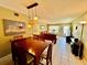 A combined dining and living space with a dining table set for six and a comfortable living area at 2457 Ecuadorian Way # 27, Clearwater, FL 33763