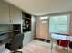Dining room with storage cabinet, built-in shelving, and natural light from a front-facing window at 2457 Ecuadorian Way # 27, Clearwater, FL 33763