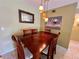 A well-lit dining room featuring a wooden table with seating for six, perfect for Gathering dinners at 2457 Ecuadorian Way # 27, Clearwater, FL 33763