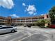 A spacious condo exterior view with a well-maintained parking lot and balconies on each level at 2457 Ecuadorian Way # 27, Clearwater, FL 33763