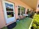 Condo's charming outdoor patio with seating, well-maintained plants, and a clear view of the entrance at 2457 Ecuadorian Way # 27, Clearwater, FL 33763