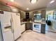 Updated kitchen features gray cabinets, stainless steel appliances, modern backsplash, and wood-look tile floors at 2457 Ecuadorian Way # 27, Clearwater, FL 33763