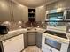 Updated kitchen showcasing gray cabinets, stainless steel microwave, granite countertops, and decorative backsplash at 2457 Ecuadorian Way # 27, Clearwater, FL 33763