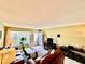 Cozy living room featuring tiled floors, neutral walls, and abundant natural light from a front-facing window at 2457 Ecuadorian Way # 27, Clearwater, FL 33763