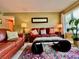 A comfortable living room with classic furniture, a stylish rug, and natural light from a nearby window at 2457 Ecuadorian Way # 27, Clearwater, FL 33763