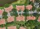 Aerial view of neighborhood homes, lush landscaping, and mature trees create a serene setting at 2516 New Haven Cir, Sun City Center, FL 33573
