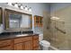 Bathroom features a single vanity, framed mirror, glass shower with tile surround, and a toilet at 2516 New Haven Cir, Sun City Center, FL 33573