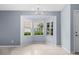 Bright dining area featuring a bay window with views of the landscaped exterior and a modern chandelier at 2516 New Haven Cir, Sun City Center, FL 33573