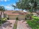 Charming villa with a red brick driveway, two-car garage, and well-maintained landscaping at 2516 New Haven Cir, Sun City Center, FL 33573