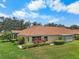 Beautiful villa with well-manicured lawn, colorful flowers, and screened lanai at 2516 New Haven Cir, Sun City Center, FL 33573