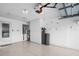 Clean garage with epoxy flooring, overhead storage, white cabinets, and a functional water filtration system at 2516 New Haven Cir, Sun City Center, FL 33573