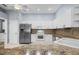 Well-equipped kitchen with white cabinetry and stainless steel appliances at 2516 New Haven Cir, Sun City Center, FL 33573