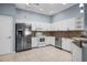 Bright kitchen featuring white cabinets, modern appliances, and tiled flooring at 2516 New Haven Cir, Sun City Center, FL 33573