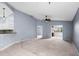 Spacious living room featuring high ceilings, neutral carpet, and an open layout at 2516 New Haven Cir, Sun City Center, FL 33573