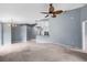 Open concept living area with tiled bar, ceiling fan and neutral walls at 2516 New Haven Cir, Sun City Center, FL 33573