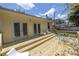 Wooden backyard deck with seating area and stairs leading to a flat, grassy backyard at 2710 10Th N St, St Petersburg, FL 33702