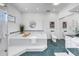 This light bathroom features a soaking tub, glass shower, and white cabinets at 2710 10Th N St, St Petersburg, FL 33702
