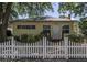 Charming single-story home featuring a welcoming entrance and a classic white picket fence at 2710 10Th N St, St Petersburg, FL 33702