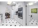 This kitchen has white cabinets, an oven range, an eat-in area, and a black and white checkered floor at 2710 10Th N St, St Petersburg, FL 33702