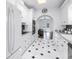 Bright kitchen with white cabinets, black and white tile floors, stainless steel appliances, and 'EAT' sign at 2710 10Th N St, St Petersburg, FL 33702