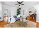 Cozy living room with hardwood floors, a sofa, and an open view into the dining area at 2710 10Th N St, St Petersburg, FL 33702