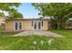 Exterior of the home with two sets of French doors and minimal landscaping at 3559 Rock Royal Dr, Holiday, FL 34691