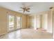 Bedroom with tile flooring, ceiling fan, and glass doors, plus closet at 3559 Rock Royal Dr, Holiday, FL 34691