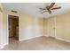 The bedroom features tile flooring, ceiling fan, and access to an en-suite bathroom at 3559 Rock Royal Dr, Holiday, FL 34691