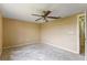 Empty bedroom with standard ceiling fan and beige walls at 3559 Rock Royal Dr, Holiday, FL 34691