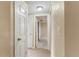 Hallway with neutral walls, tile floor, and multiple doors at 3559 Rock Royal Dr, Holiday, FL 34691