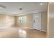 Bright living room featuring tile floors, neutral walls, and a window for natural light at 3559 Rock Royal Dr, Holiday, FL 34691