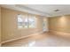 Inviting living room with tile flooring, showcasing natural light and a neutral color palette at 3559 Rock Royal Dr, Holiday, FL 34691