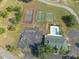Aerial shot highlighting the community clubhouse, pool, parking lot, tennis, basketball, and shuffleboard courts at 3642 Fantasy Way, Brooksville, FL 34604