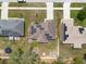 A top-down shot reveals houses with solar panels, fenced yards, and nearby street access, highlighting suburban living at 3642 Fantasy Way, Brooksville, FL 34604