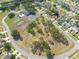 Aerial view of community amenities featuring tennis, basketball, and shuffleboard courts, a swimming pool, clubhouse, and beautiful lawns at 3642 Fantasy Way, Brooksville, FL 34604