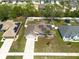 High-angle of the home showcasing its manicured lawn, solar panels, and convenient two-car garage at 3642 Fantasy Way, Brooksville, FL 34604