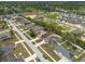 A high-angle shot shows a community with many single-Gathering homes, some equipped with solar panels, and green spaces at 3642 Fantasy Way, Brooksville, FL 34604
