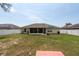 Large backyard featuring a partial view of a screened-in patio and solar panels on the roof at 3642 Fantasy Way, Brooksville, FL 34604