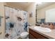 Cozy bathroom with a vanity, a sink, a toilet, and a shower with a curtain at 3642 Fantasy Way, Brooksville, FL 34604