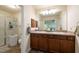 Bathroom featuring double sinks, granite countertops, framed mirrors, and walk-in shower at 3642 Fantasy Way, Brooksville, FL 34604